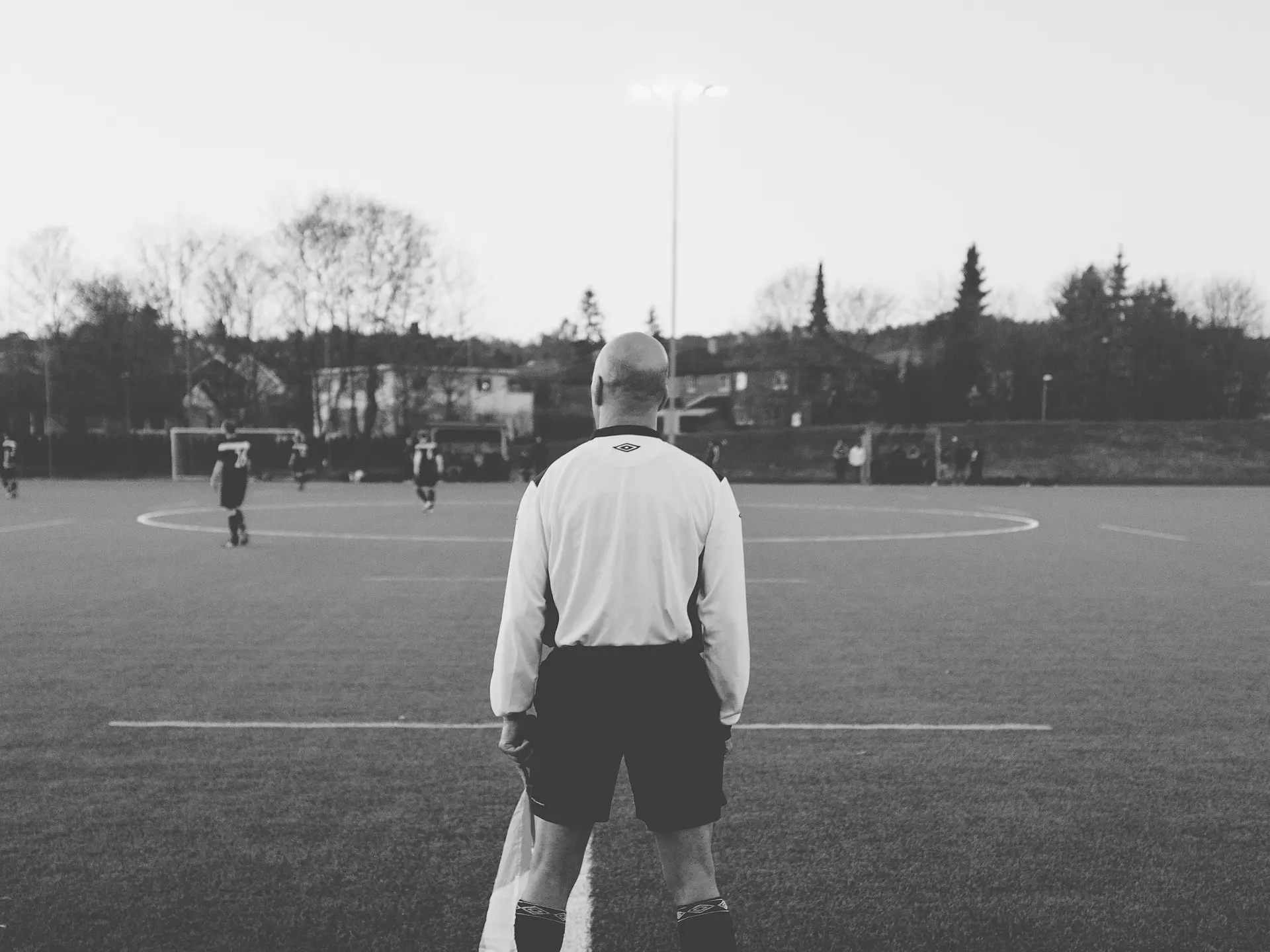 Soccer assistant referee monitoring the game
